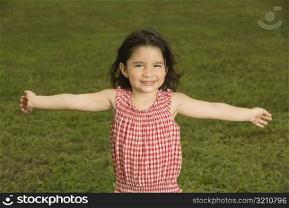 Portrait of a girl smiling with her arms outstretched