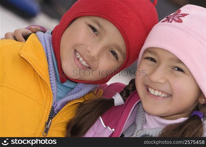 Portrait of a girl smiling with her brother