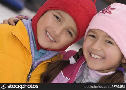 Portrait of a girl smiling with her brother
