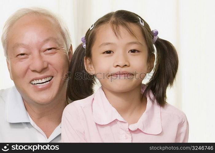 Portrait of a girl smiling with her grandfather