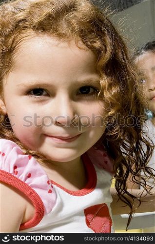 Portrait of a girl smirking with her classmate in the background
