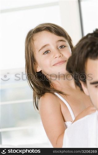 Portrait of a girl standing behind her father