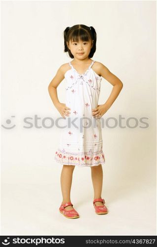 Portrait of a girl standing with arms akimbo