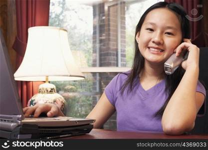 Portrait of a girl talking on a cordless telephone