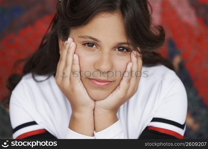 Portrait of a girl thinking with her hands on her chin