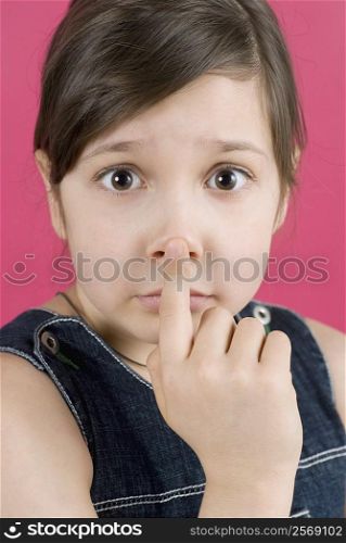 Portrait of a girl touching her nose
