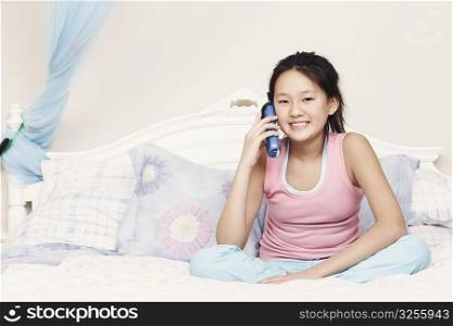 Portrait of a girl using a cordless telephone