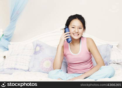 Portrait of a girl using a cordless telephone