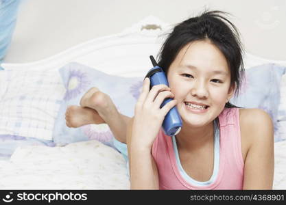 Portrait of a girl using a cordless telephone