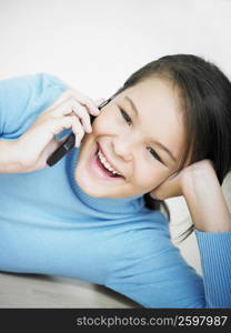 Portrait of a girl using a mobile phone and smiling