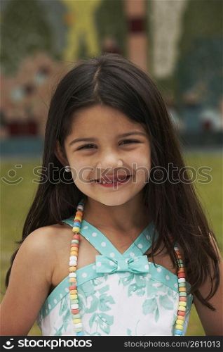 Portrait of a girl wearing a candy necklace and smiling