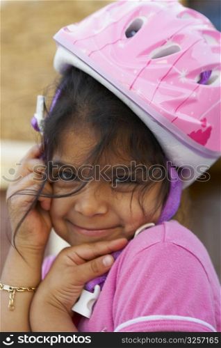 Portrait of a girl wearing a cycling helmet and smiling