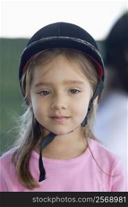Portrait of a girl wearing a riding hat