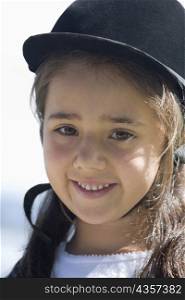 Portrait of a girl wearing a riding hat and smiling