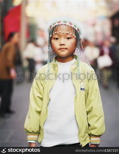 Portrait of a girl wearing an ornate headdress