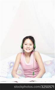 Portrait of a girl wearing headphones listening to music