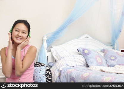 Portrait of a girl wearing headphones listening to music