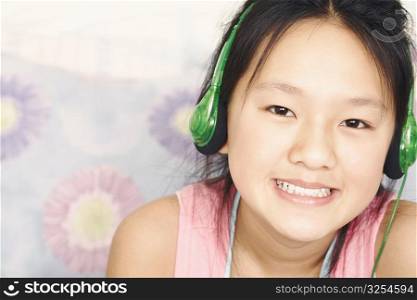 Portrait of a girl wearing headphones listening to music