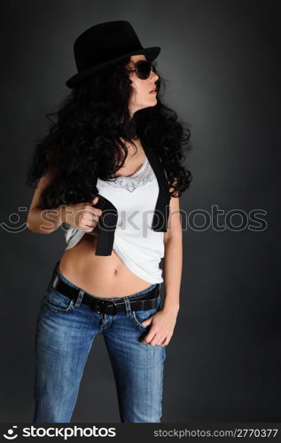 Portrait of a girl wearing sunglasses and a hat on a black background