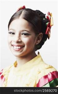 Portrait of a girl wearing traditional clothing and smiling
