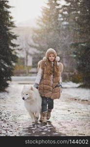 Portrait of a girl with a dog walking along the autumn alley.. A girl walks on a leash your dog 9859.