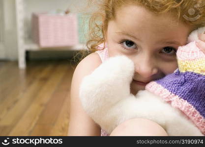 Portrait of a girl with a toy