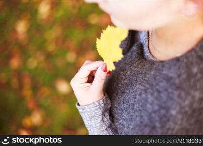 portrait of a girl with an autumn leaf in her hand