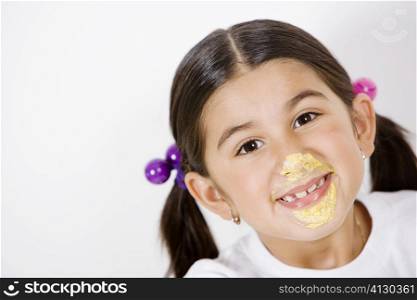 Portrait of a girl with cream on her face