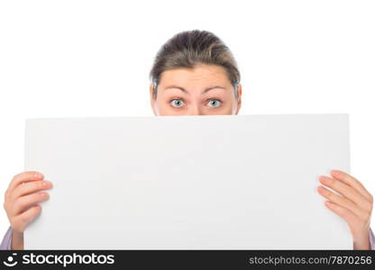 portrait of a girl with eyes wide open with a large white poster