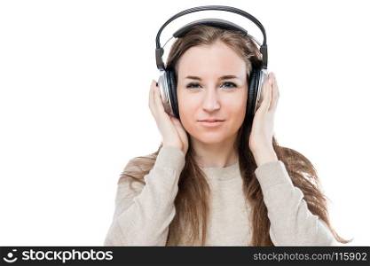 portrait of a girl with headphones listening to good music on a white background isolated