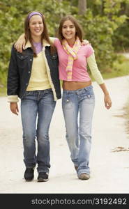 Portrait of a girl with her arm around her friend and smiling