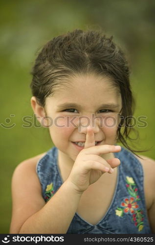 Portrait of a girl with her finger on her lips