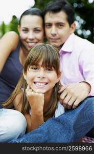 Portrait of a girl with her parents sitting and smiling