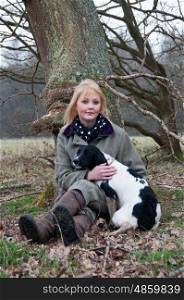 Portrait of a girl with her spaniel in the countryside