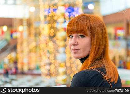 portrait of a girl with red hair in the mall