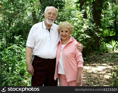 Portrait of a good looking, active senior couple taking a walk in the park.