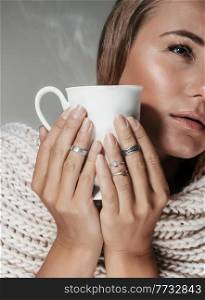 Portrait of a Gorgeous Young Girl with Stylish Natural Makeup Drinking Tasty Hot Coffee in Cold Autumn Day. Face Part. Fashion Look.. Pretty Woman with Cup of Coffee