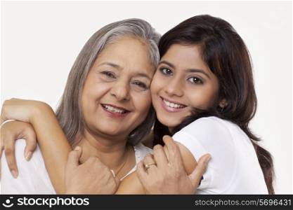 Portrait of a granddaughter embracing her grandmother