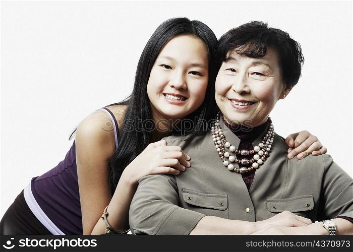 Portrait of a grandmother and her granddaughter smiling