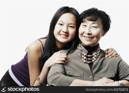 Portrait of a grandmother and her granddaughter smiling