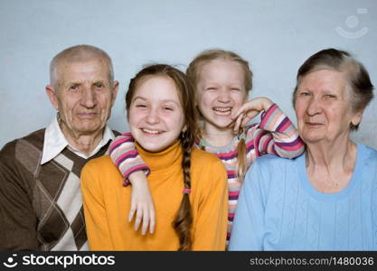 portrait of a great-grandmother, great-granddaughters and grandfather, close-up