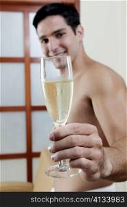 Portrait of a groom holding a champagne flute