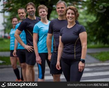 portrait of a group healthy people jogging in city park, runners team on morning training. portrait of runners team on morning training