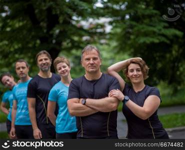 portrait of a group healthy people jogging in city park, runners team on morning training. portrait of runners team on morning training