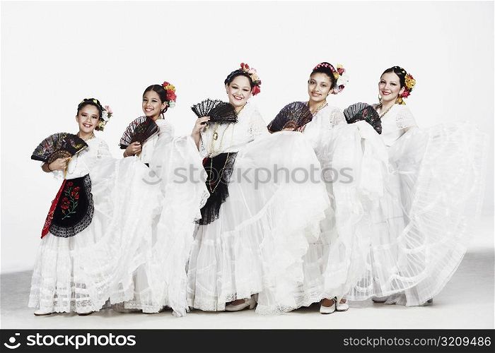 Portrait of a group of female dancers holding folding fans