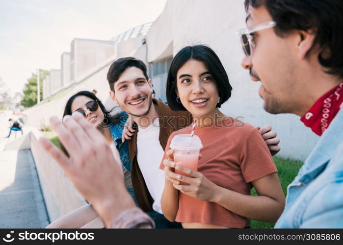 Portrait of a group of friends having fun together and enjoying good time while drinking fresh fruit juice. Lifestyle and friendship concept.