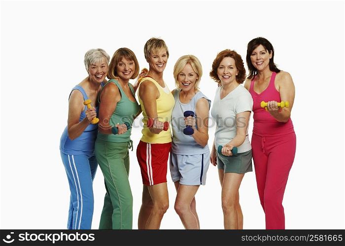 Portrait of a group of mature women holding dumbbells and smiling