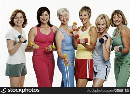 Portrait of a group of mature women holding dumbbells and smiling
