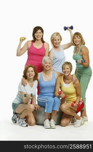 Portrait of a group of mature women holding dumbbells and smiling