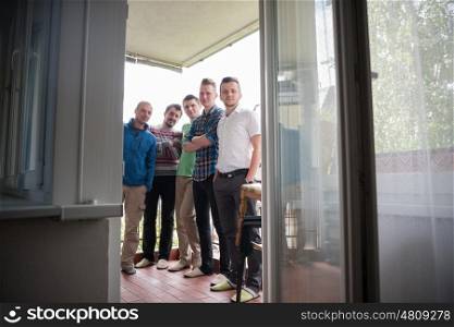 portrait of a group of men standing on the balcony